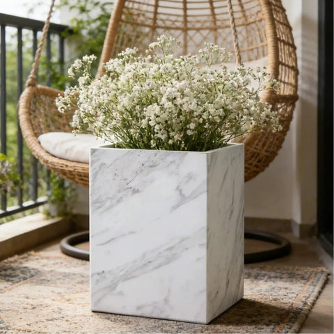 Lux Marble Wastebasket Real Stone Trash Can in a rectangular shape with a sleek white marble finish on a porch.