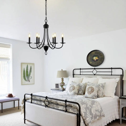 Black 6 Light Farmhouse Chandelier for Dining Room 22.4 Inch with E12 Base hanging in a cozy rustic bedroom