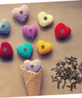 Colorful knitted hearts with Fifty Piece Double Foot Spikes Metal Brads For Scrapbooking And DIY Crafts Durable Paper Fasteners scattered.