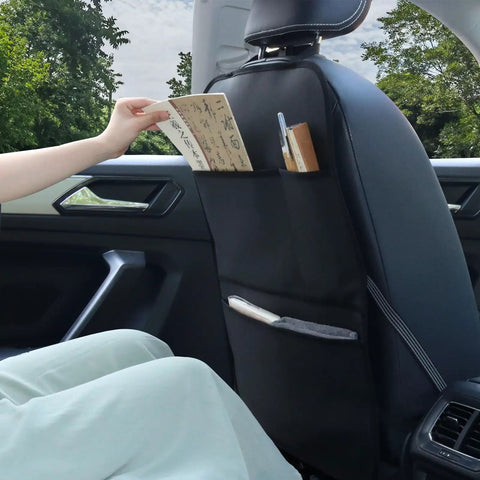 View of waterproof leather back seat protector with three storage pockets, used as an anti-kick mat for kids and pets in a car.