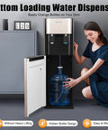Woman using Dual Temperature Water Dispenser with fast cold and hot water, 5 gallon stainless steel water cooler, bottom load design.