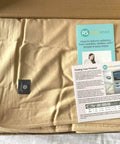 EMF Shielding Large Bed Blanket Made From Organic Cotton With Silver Lining, 57 by 78 inches, shown in packaging with instruction leaflets