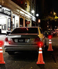 28 Inch Collapsible Traffic Cones Two Pack With LED Lights And Reflective Collar near parked car at night