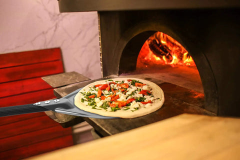 Turning Pizza Peel With 8 Inch Aluminum Round Paddle For Outdoor Ovens 23 Point 6 Inch Total Length nonstick tool in use