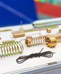 Sturdy Manganese Steel Mechanical Extension Spring With Silver Hot Heating Wire Coil Kit For Easy Install And Strong Hold In Industrial Or Home Projects, black coil spring on white tray