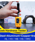 Top Shelf Digital Leeb Hardness Tester Portable Handheld Metal Durometer Built Tough For Thin Steel Parts And Hard Surface Layers With Zero Hassle Dual Coil Technology measuring metal surface hardness in hand.