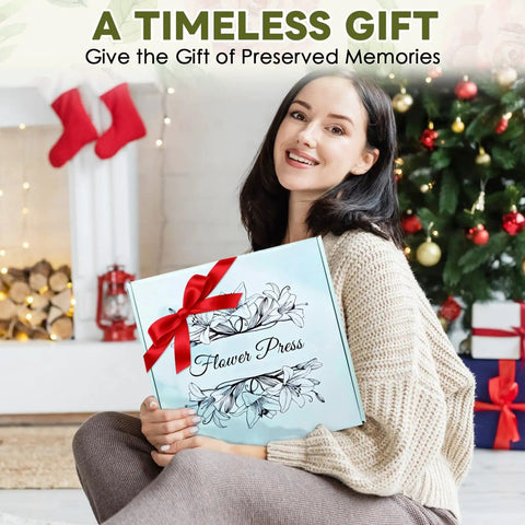 Woman holding 11x11 Inch Dope Extra Large Flower Press Kit With 10 Wooden Layers for adults and teens, Christmas setting in background.