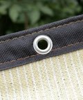 Close-up of beige Shade Cloth 7x7ft With 90 Percent Sun Blocking, Durable HDPE Shade Mesh Tarps showing grommet and taped edges