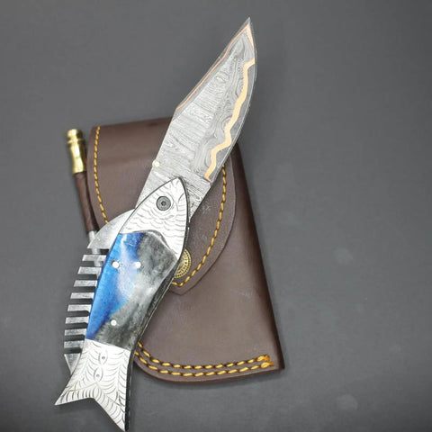 Fish Style Folding Knife With Ladder Pattern Damascus Blade And Blue Resin Handle on leather sheath