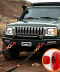 Heavy Duty Three Quarter Inch D Ring Shackles Three Pack For Tow Strap Winch And Vehicle Recovery With Red Powder Coat Built Tough For Real World Pulls Twenty Eight And A Half Ton Break Strength 57000 Lbs 9500 Lbs Working Load Limit Industrial Grade attached to vehicle bumper in off-road setting