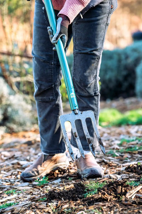 Gardener using Compact Steel-Handle Border Fork With A 6-Inch Shorter Design For Tight Spots Built From 90 Percent Recycled High-Strength Steel.