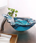 Bathroom Vessel Sink, Flower Shape Blue Vanity Sink Bowl with waterfall faucet on wooden countertop.