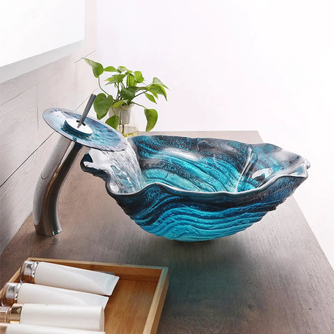 Bathroom Vessel Sink, Flower Shape Blue Vanity Sink Bowl with waterfall faucet on wooden countertop.