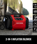 Dual Power Tire Inflator Portable Air Compressor With 12V Car Plug And 120V Home Use Up To 150 PSI Digital Gauge Auto Shut Off LED Light Handy Air Pump For Cars Bikes And Inflatables in red under a car tire.