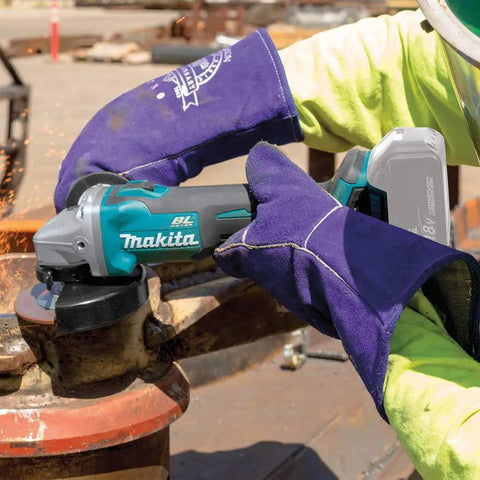 Worker using 18V LXT Brushless Cordless Cut-Off And Angle Grinder with automatic speed change for metal cutting on job site.