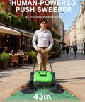 Heavy Duty 43 Inch Walk Behind Floor Sweeper Manual Push Broom For Warehouse And Shop Floors With A Beefy 15 Gallon Hopper cleaning a street.