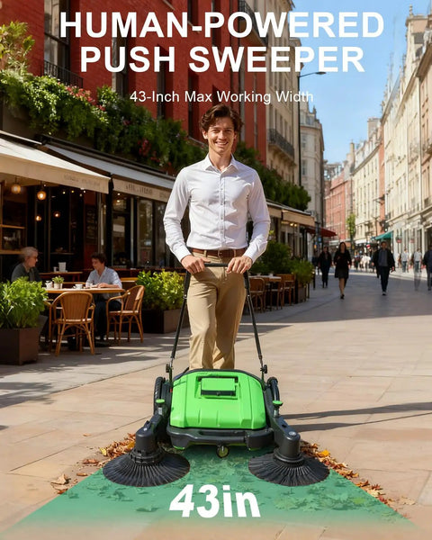 Heavy Duty 43 Inch Walk Behind Floor Sweeper Manual Push Broom For Warehouse And Shop Floors With A Beefy 15 Gallon Hopper cleaning a street.