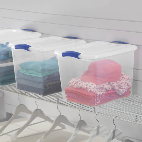 Heavy Duty Clear Storage Bins 2 Pack With Tight Blue Latches showcasing neatly folded clothes on a closet shelf.