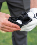 Person holding a Compact Golf Club And Ball Cleaning Bag With Waterproof Liner, Detachable Clip, Machine Washable Microfiber Exterior.