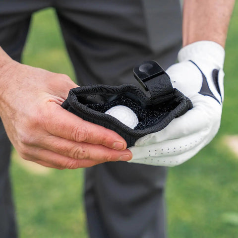 Person holding a Compact Golf Club And Ball Cleaning Bag With Waterproof Liner, Detachable Clip, Machine Washable Microfiber Exterior.