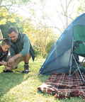 Father and son using Beefed-Up 750Lb Paracord 4mm 11-Strand Tactical Parachute Cord for camping with a tent, focus on utility rope use.