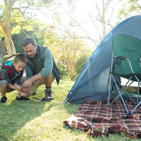 Father and son using Beefed-Up 750Lb Paracord 4mm 11-Strand Tactical Parachute Cord for camping with a tent, focus on utility rope use.