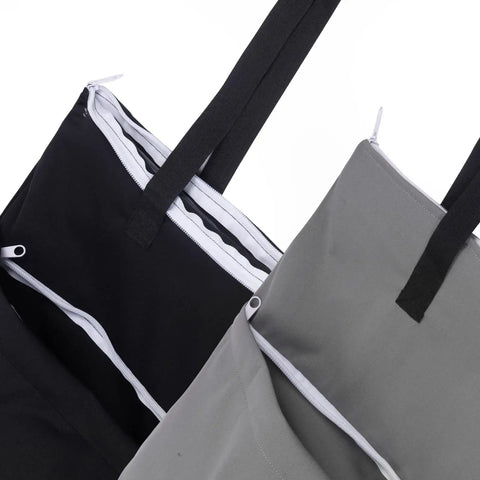 Close-up of 2 Pack Large Wet Dry Bag For Cloth Diapers Waterproof Hanging Organizer With Double Zippered Pockets in black and grey.