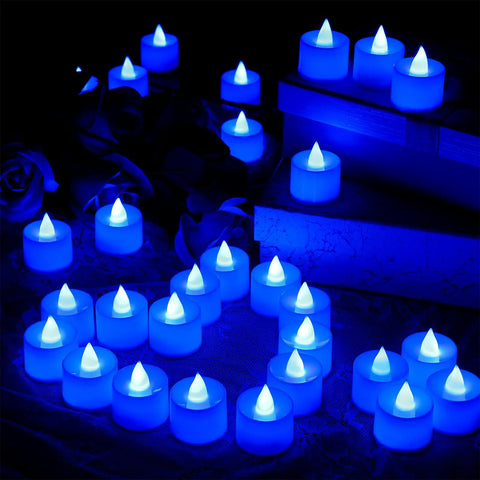 Blue flameless LED tea lights glowing in the dark, part of 72 Pack Blue Flameless LED Tea Light Candles Battery Operated For Wedding Table Decor Romantic Nights Anniversary Honeymoon Mood Lighting Perfect For Weddings And Parties Safe Flame Free Glow.