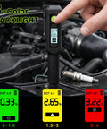 Heavy Duty Brake Fluid Tester Pen With Digital LCD Screen measuring moisture levels on a car engine, showing fluid safety levels.