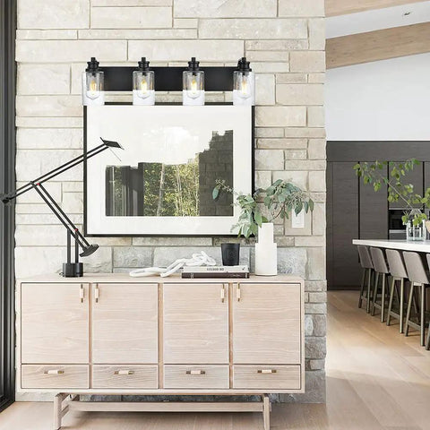 Four Light Black Wall Sconce Vanity Light With Seedy Glass Shades 28 Inch mounted above a sideboard against stone wall