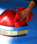 Hand using Industrial Grade Cotton Shop Towels 14 By 12 Inches 500 Pack Reusable Cleaning Rags on car taillight