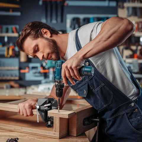 Person using a Cool Mini Table Vise With Adjustable Clamp Jaw for woodworking, featuring a drill and precision assembly.