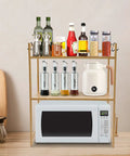 Top Shelf Heavy Duty Double Tier Microwave Stand With Cutting Board Holder And Four Utensil Hooks For Countertop Storage Kitchen Organization No Sweat Setup displaying sauces, spices, and a microwave.