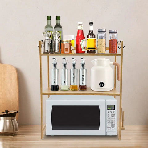Top Shelf Heavy Duty Double Tier Microwave Stand With Cutting Board Holder And Four Utensil Hooks For Countertop Storage Kitchen Organization No Sweat Setup displaying sauces, spices, and a microwave.