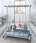 Heavy Duty Stainless Steel Broom And Mop Organizer Cart With Floor Standing Storage For Garage And Shop Perfect Mop Rack And Broom Holder For Cleaning Supplies Cart At Home Garden School Hotel Hospital Factory in a kitchen setting with cleaning tools hanging.