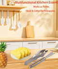 Stainless Steel Pineapple Eye Peeler and V Shape Cutter With Clip on kitchen counter next to sliced pineapple and whole fruit.