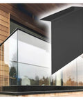 Heavy Duty Glass Railing System For Deck And Balcony Featuring Rock Solid Spigot Clamps With Flexible Floor Or Side Mount Hardware And Premium Aluminum Posts In Matte Black Covers on a balcony installation.