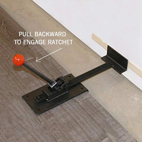 Hardwood Flooring Jack Positioning Tool for Easy Installations and Tight Fits used on laminate floor with ratchet handle engaged