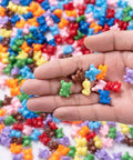 Super Cool Rainbow Counting Bears Set With Nine Rad Colors Perfect For Toddler Math Manipulatives And Preschool Activities in a hand.
