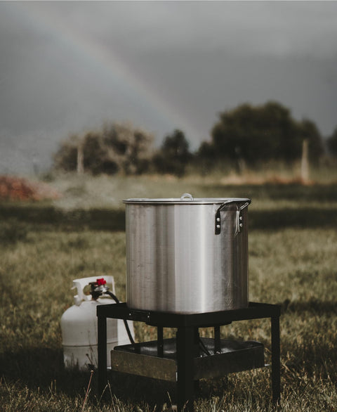 Seafood Boil Kit With Propane Burner And Regulator, 60 Quart Pot With Basket, Heavy Duty Outdoor Crab Boil Pot on grass.