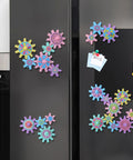 36 Piece Magnetic Gear Set For STEM Learning And Hands On Magnetic Construction Toy with interchangeable spin gears on fridge.