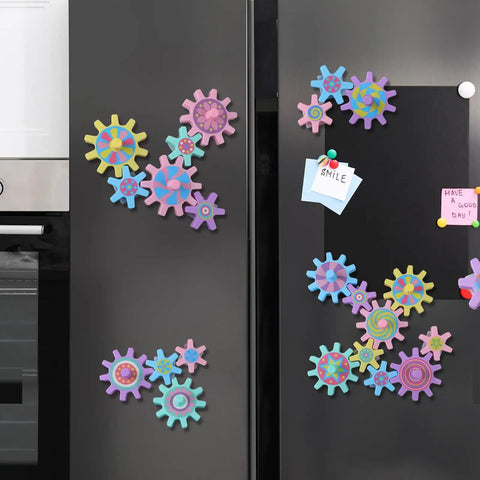 36 Piece Magnetic Gear Set For STEM Learning And Hands On Magnetic Construction Toy with interchangeable spin gears on fridge.