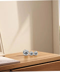 Steel and plastic balls on a wooden surface for 5-Piece Pendulum Ball Assembly Kit For Physics Education And Mechanics Learning.