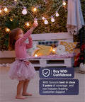 Young child reaching for string lights outdoors, wearing a pink dress, highlighting Super Bright A19 LED Light Bulbs.
