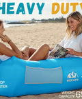 Two women relaxing on blue Inflatable Couch Air Lounger Chair For Camping And Beach Trips Portable Blow Up Sofa at the beach.