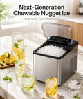Top Rated Countertop Nugget Ice Maker With One Touch Deep Cleaning And Sleek Arctic Silver Trim Designed To Quickly Whip Up Soft Chewable Pebble Ice That Chills Your Daily Drinks Lightning Fast on kitchen counter with glasses.