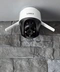 2K Pan Tilt Outdoor WiFi Security Camera For Home Or Business With 360 Degree View mounted on stone wall, IP66 weatherproof
