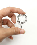 Hand holding 8 Piece Door Handle Spring Set For Knob And Lever Latch Replacement DIY Friendly Internal Coil Repair Spindle Lock Torsion Return Spring 16 Gauge Wire Includes 8 Sizes Check Size Carefully Before Ordering coil spring