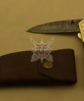 Damascus Steel Folding Knife With Rosewood Handle And Floral Brass Bolster, 4.5 Inch Overall Drop Point Blade, Leather Sheath Included
