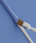 Paintbrush with blue paint on a paintable cover from 157 Inch Cord Cover Kit Easy Peel And Stick Self Adhesive Wire Hiders